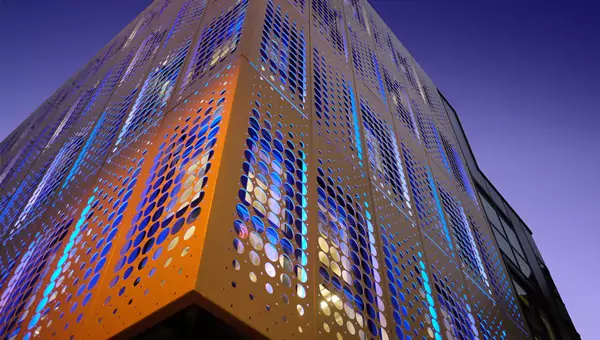 Rendering of perforated aluminum wall panels under night light